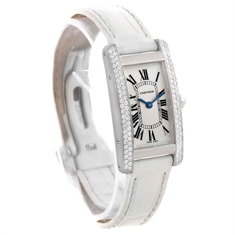 This image shows a tilted angle of the Cartier Tank Americaine WB701851 Women
s White Gold Silver Dial WB701851 Women
s White Gold Silver Dial watch, displaying its face, dial, and part of its strap.