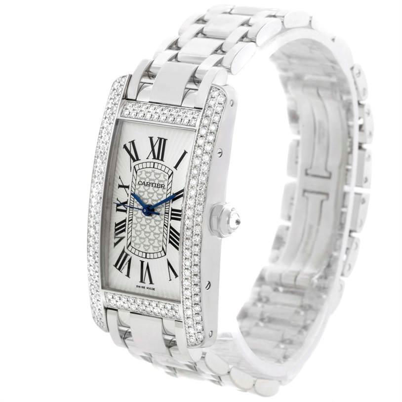 The image shows a Cartier Tank Americaine WB710001 Women
s White Gold Silver Dial WB710001 Women
s White Gold Silver Dial watch at a three-quarter angle, highlighting its diamond-encrusted bezel and silver bracelet.
