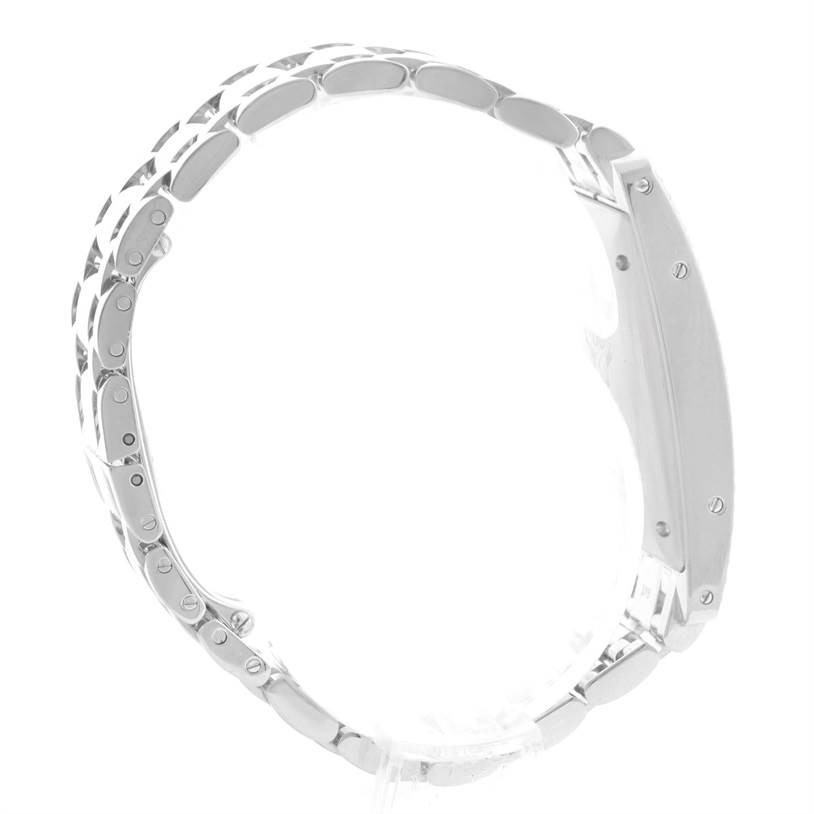 The image shows a side view of the Tank Américaine model by Cartier, highlighting its metallic watch band and case.