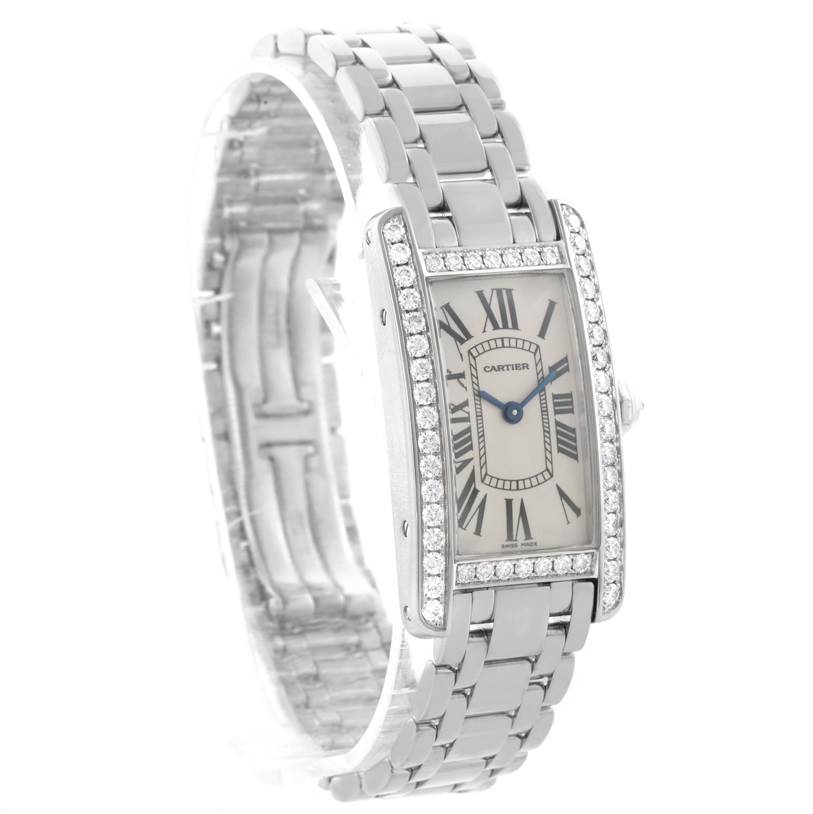 The image shows an angled view of a Cartier Tank Americaine WB7073L1 Women's White Gold Silver Dial WB7073L1 Women's White Gold Silver Dial watch, highlighting its face, bracelet, and diamond-studded bezel.