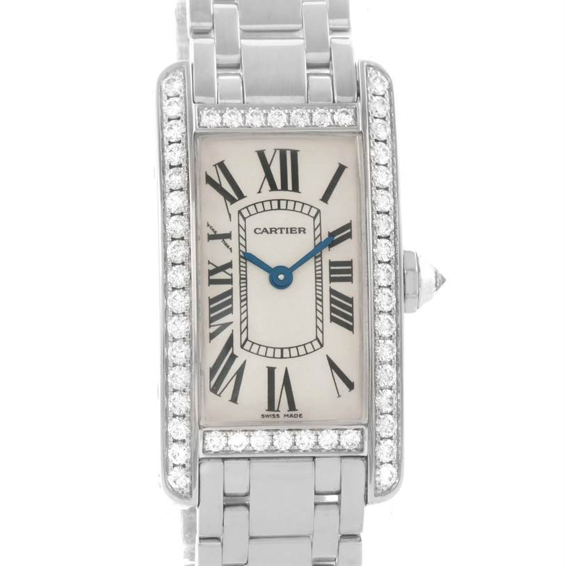 The image shows a frontal view of a Cartier Tank Americaine WB7073L1 Women's White Gold Silver Dial WB7073L1 Women's White Gold Silver Dial watch with a rectangular face, Roman numerals, and a diamond-set bezel.