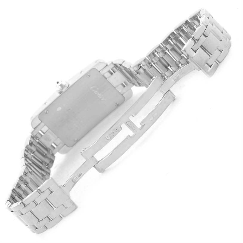 The image shows the back and opened clasp of the Cartier Tank Américaine watch, highlighting its chain bracelet and deployment clasp.
