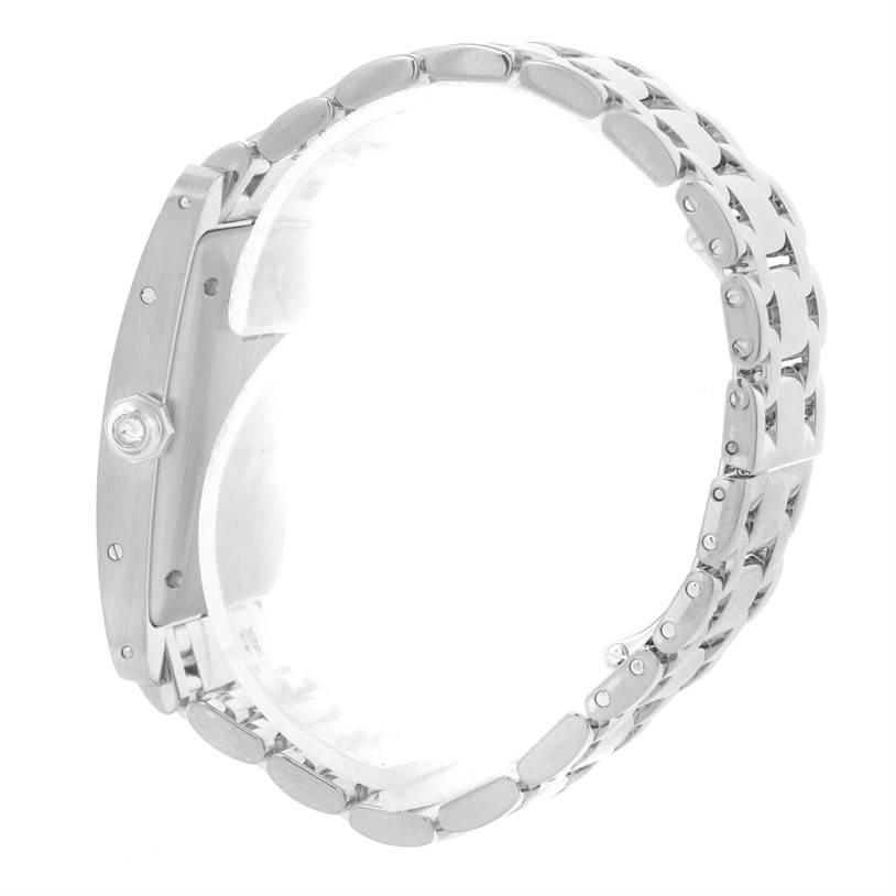 The image shows a side view of the Cartier Tank Americaine 2423 Women's White Gold Silver Dial 2423 Women's White Gold Silver Dial watch, highlighting its case, crown, and metal bracelet.