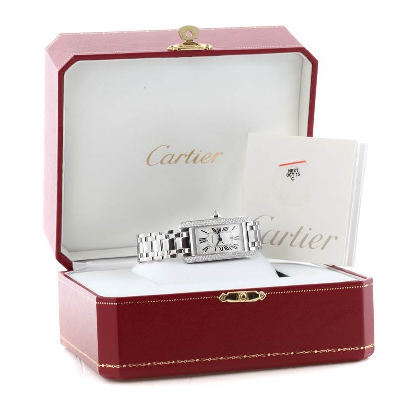 The Cartier Tank Americaine 2423 Women's White Gold Silver Dial 2423 Women's White Gold Silver Dial watch is shown in its open red box with documentation beside it.