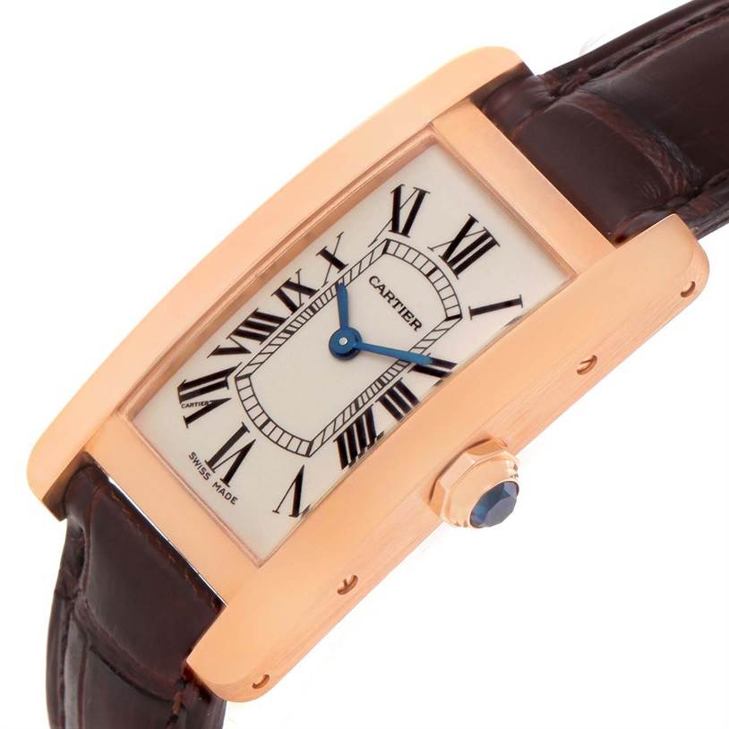 The Tank Americaine model by Cartier is shown at an angle, displaying its face, case, and part of the leather strap.