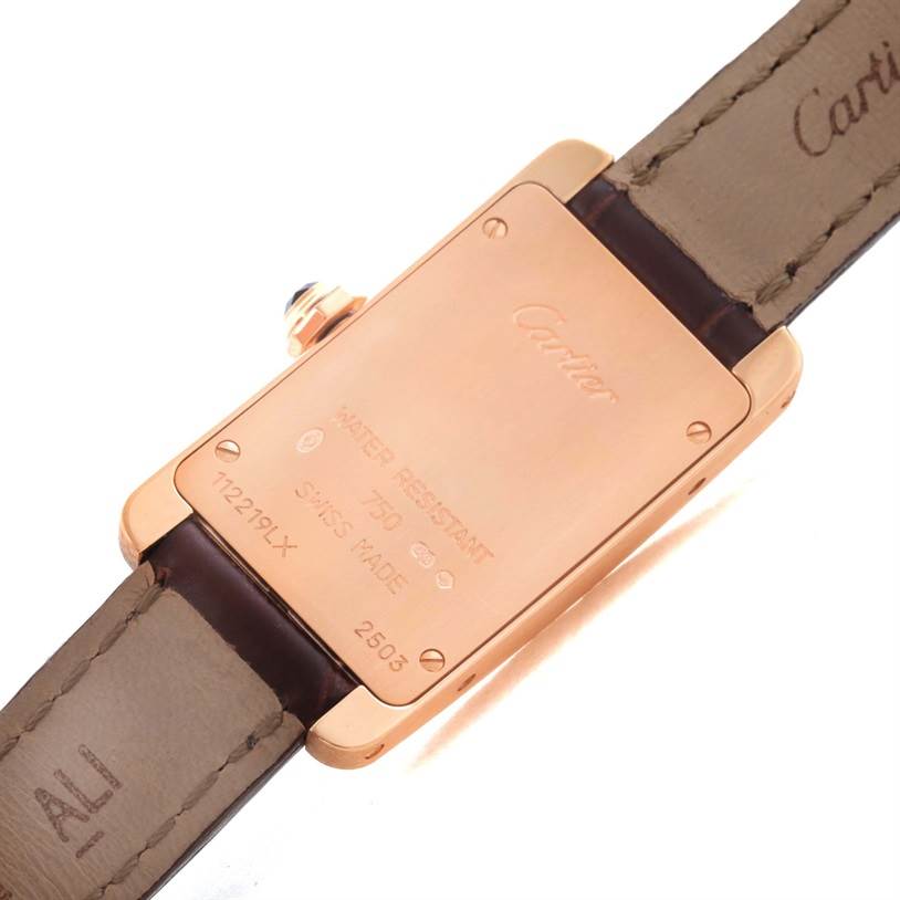 The image shows the back and strap of a Cartier Tank Americaine W2607456 Women's Rose Gold Silver Dial W2607456 Women's Rose Gold Silver Dial watch, highlighting the case back and branding.