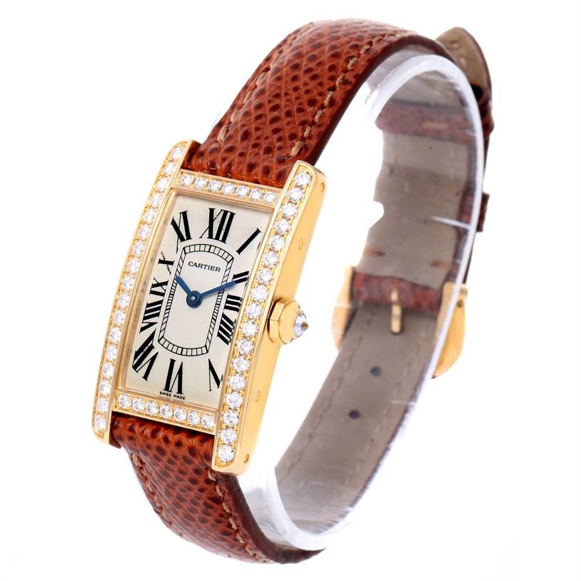 The image shows a Cartier Tank Américaine watch at a slight angle, highlighting its leather strap and diamond-encrusted bezel.
