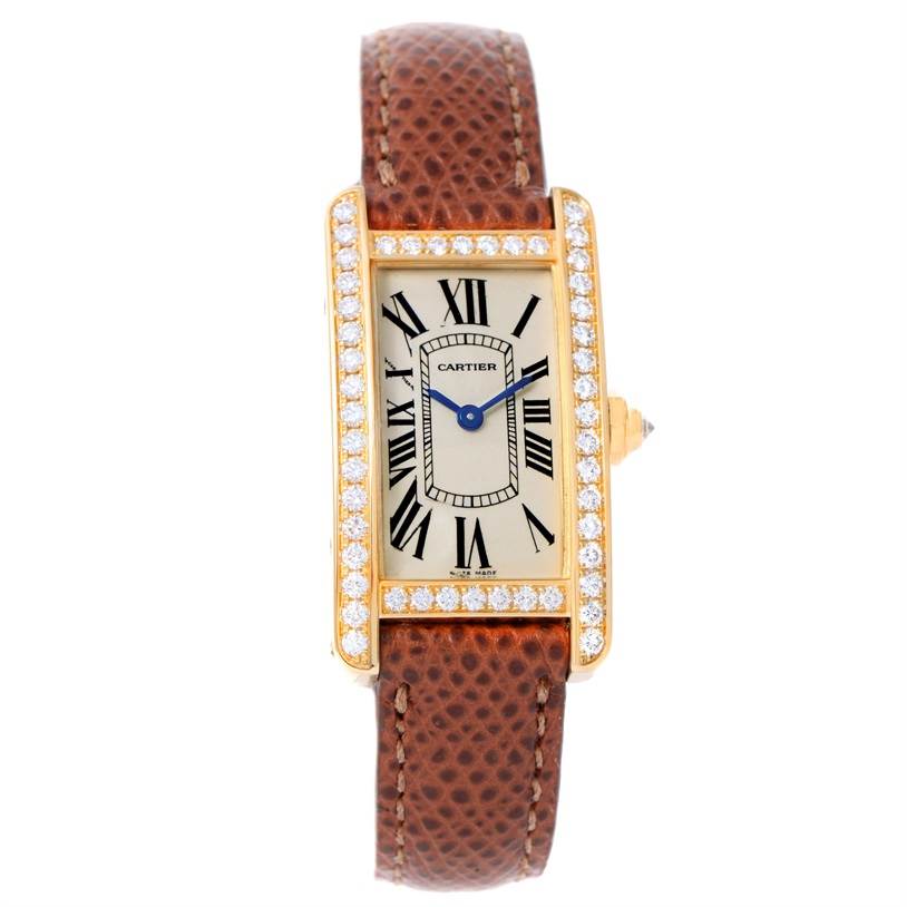 The image shows a front view of the Cartier Tank Américaine watch, showcasing its rectangular face, diamond bezel, and leather strap.