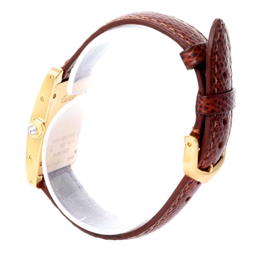 This side view of the Cartier Tank Americaine WB707231 Women
s Yellow Gold Silver Dial WB707231 Women
s Yellow Gold Silver Dial watch shows the leather strap, buckle, and part of the case with a visible crown.