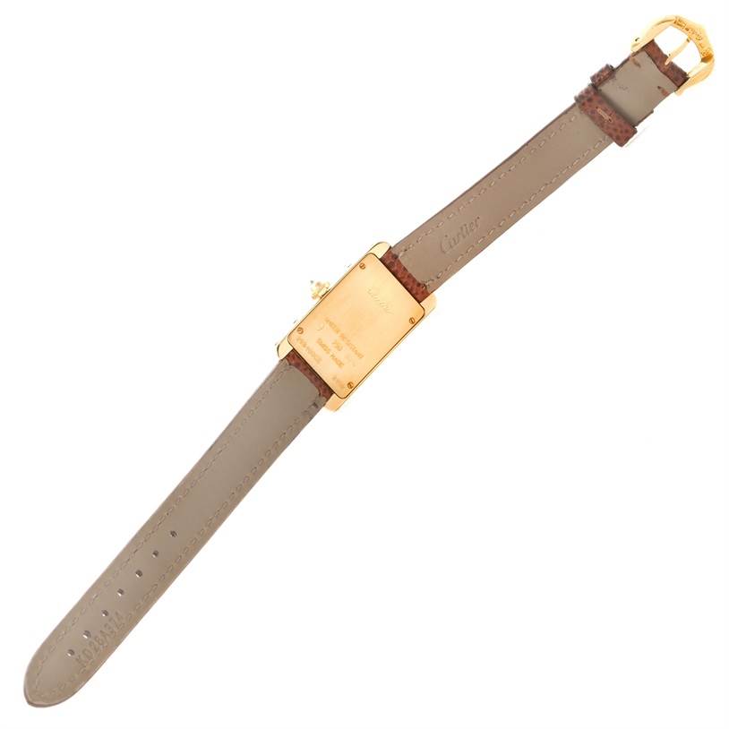 The image shows the back view of a Cartier Tank Americaine WB707231 Women
s Yellow Gold Silver Dial WB707231 Women
s Yellow Gold Silver Dial watch, displaying the case, strap, and buckle.