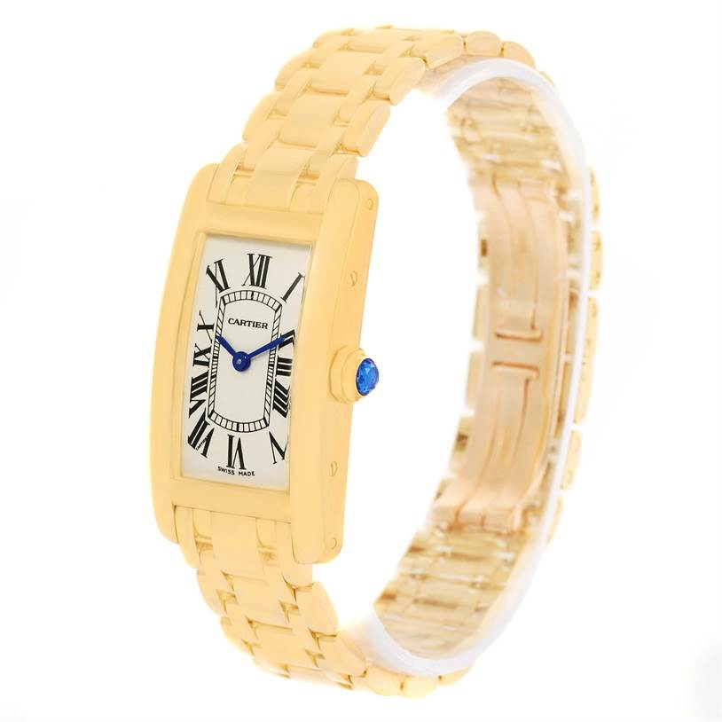 The image shows a Cartier Tank Americaine W26015K2 Women's Yellow Gold Silver Dial W26015K2 Women's Yellow Gold Silver Dial model watch at a right front angle, highlighting its face and gold bracelet.