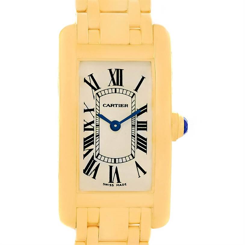 This is a front view of a Cartier Tank Américaine watch showing the dial, Roman numerals, and blue hands, with part of the gold bracelet visible.