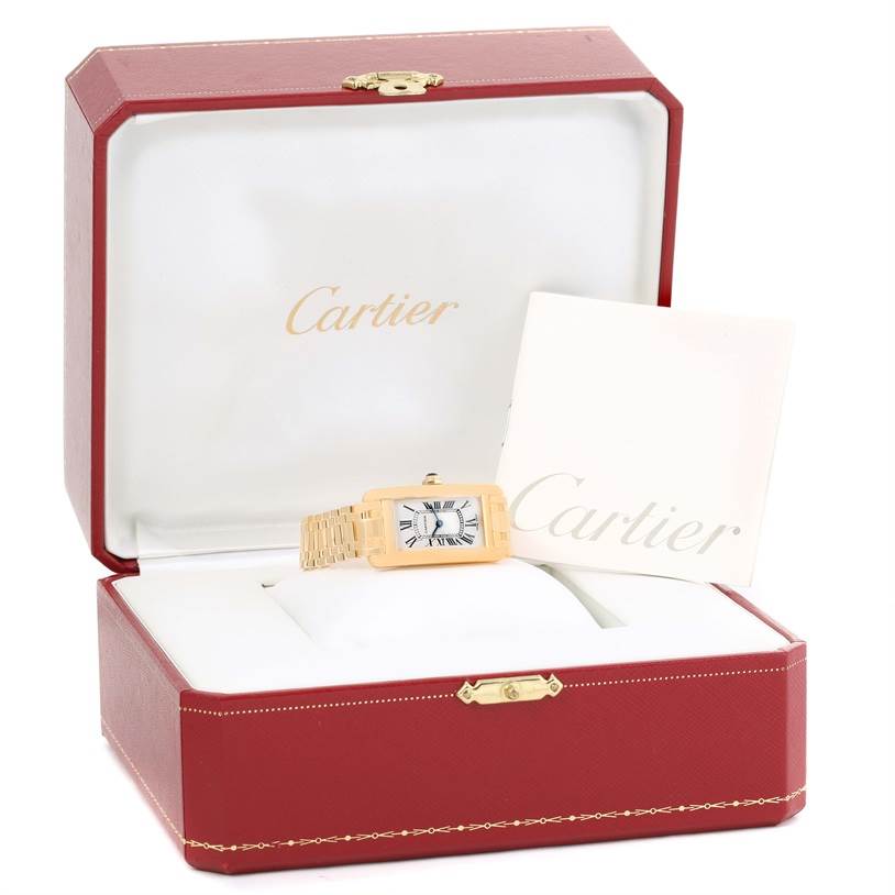 The Tank Américaine Cartier watch is displayed in a red Cartier box with accompanying paperwork.