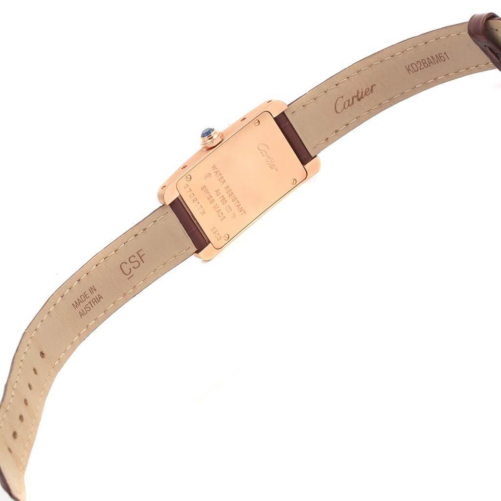 The image shows the back view of the Cartier Tank Américaine watch, including its case back and straps.