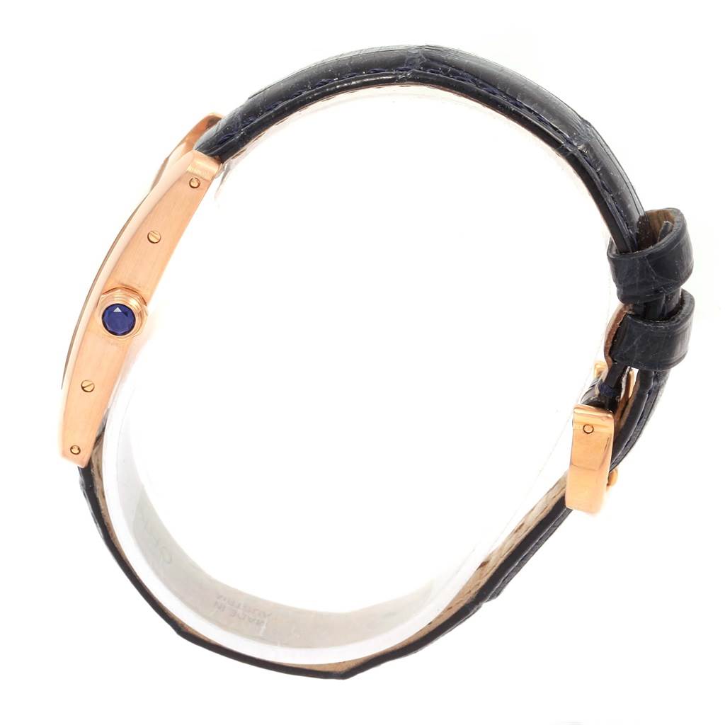 The image shows a Cartier Tank Americaine W2607456 Women
s Rose Gold Silver Dial W2607456 Women
s Rose Gold Silver Dial watch from a side angle, highlighting its case and leather strap.