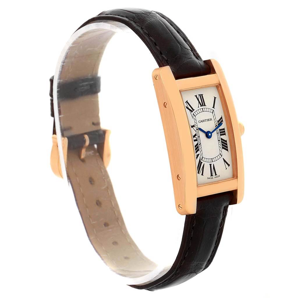 This image shows a Cartier Tank Américaine watch at a slight upward angle, displaying the face, case, and parts of the strap.