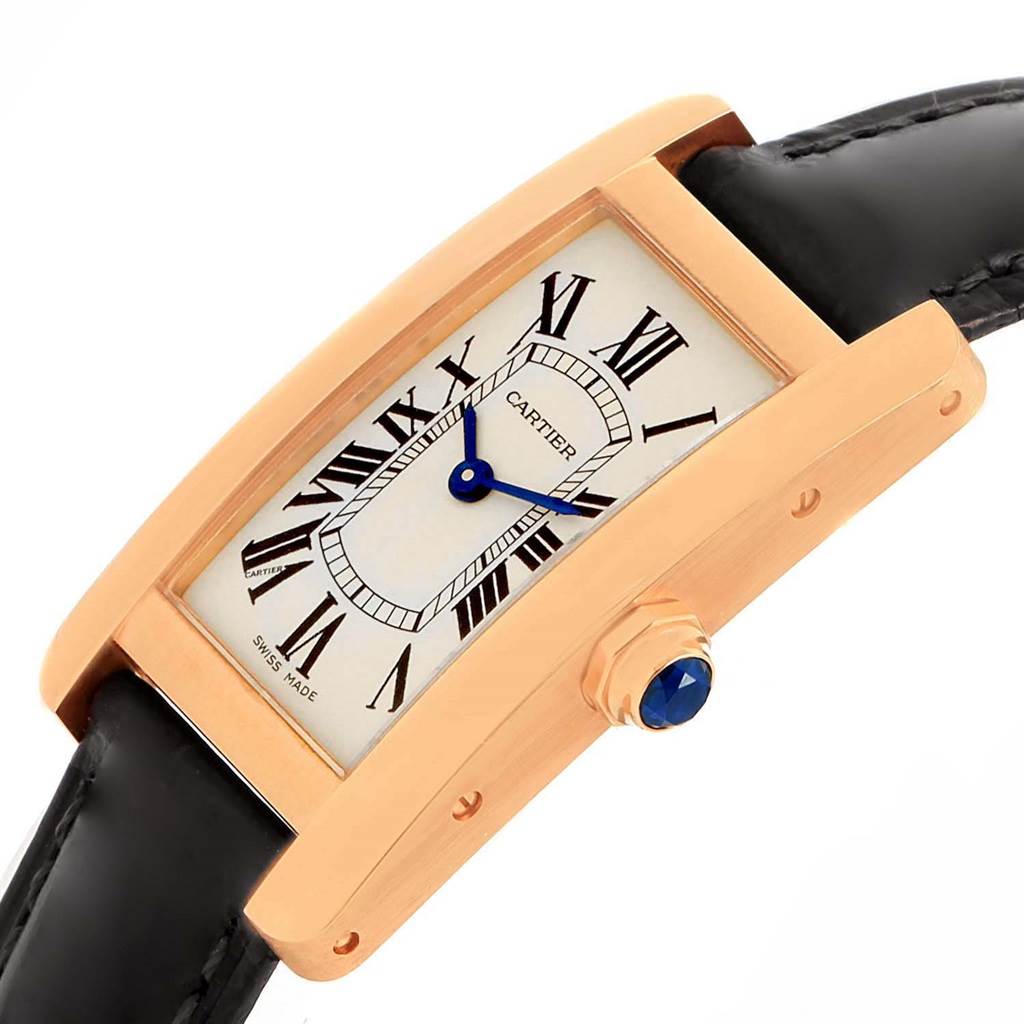 The image shows a close-up, side angle view of the Cartier Tank Américaine watch, highlighting its dial, case, crown, and leather strap.