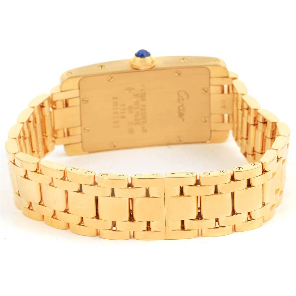 This image shows the back and bracelet of a Cartier Tank Americaine W26015K2 Women
s Yellow Gold Silver Dial W26015K2 Women
s Yellow Gold Silver Dial watch, highlighting the gold case and linked bracelet.