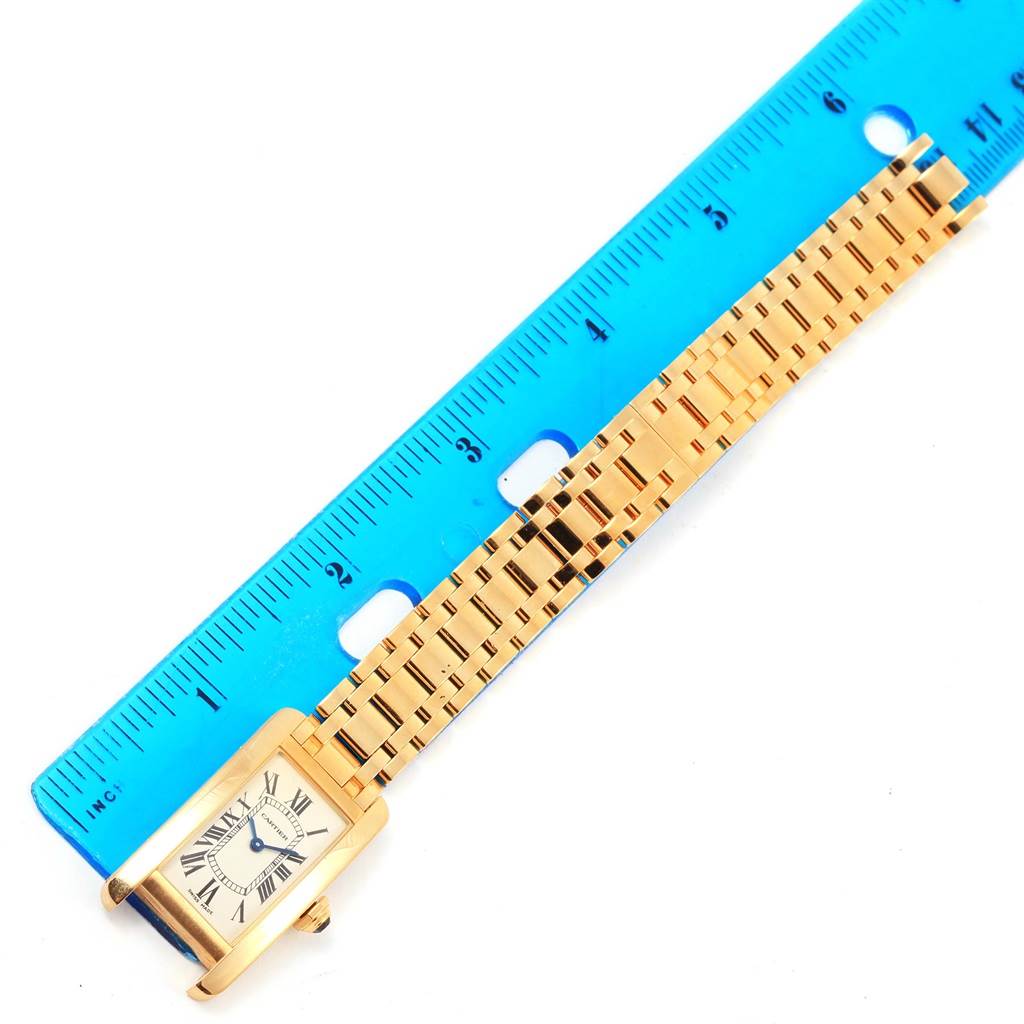 The image shows a Tank Americaine model by Cartier, with the face and part of the bracelet visible next to a ruler.