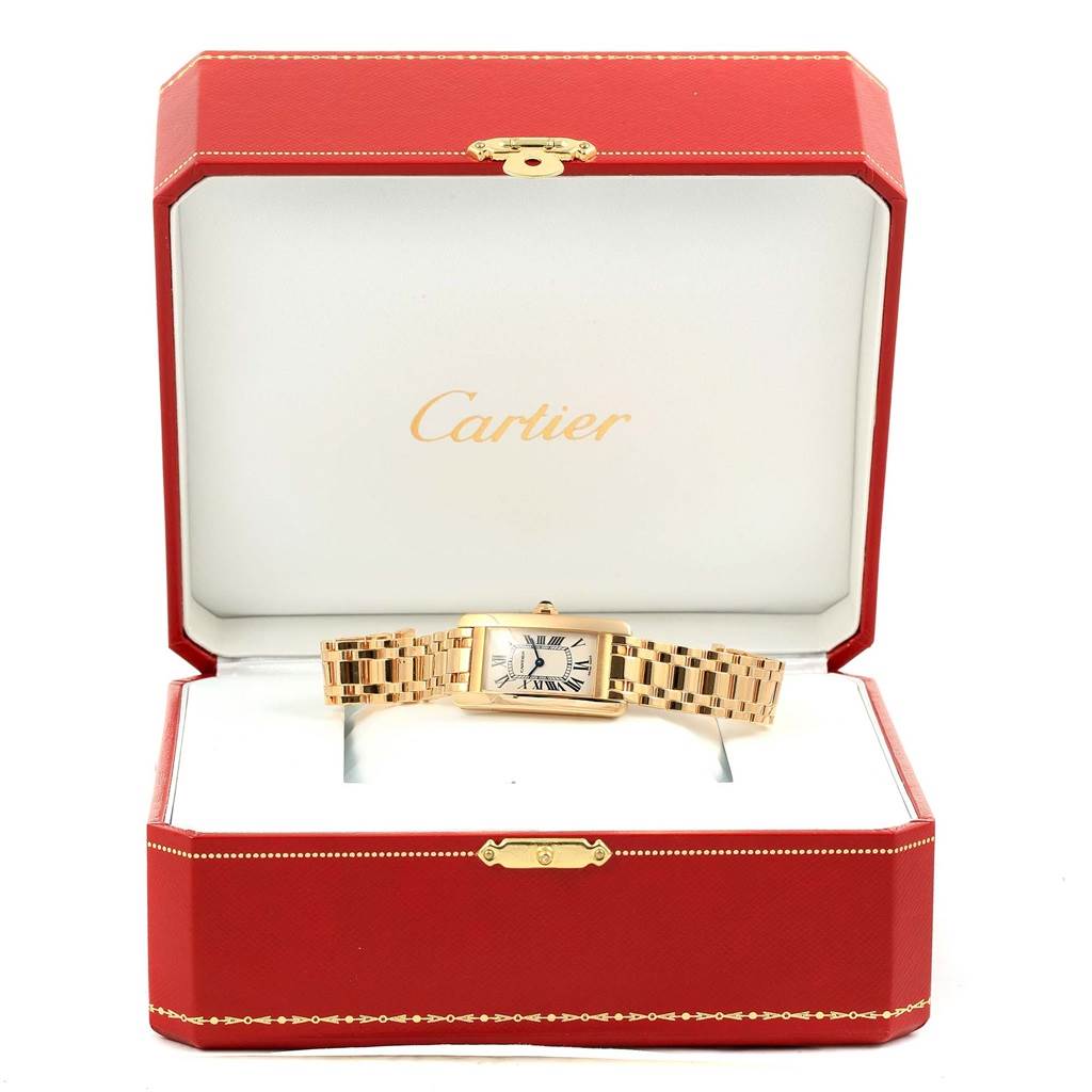 The Cartier Tank Americaine W26015K2 Women
s Yellow Gold Silver Dial W26015K2 Women
s Yellow Gold Silver Dial watch is shown in an open box, displaying the face and full bracelet.
