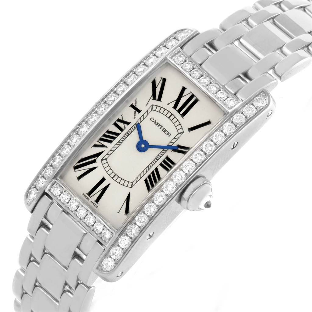 The image shows a Cartier Tank Americaine WB7073L1 Women's White Gold Silver Dial WB7073L1 Women's White Gold Silver Dial watch at an angled view highlighting its face, bracelet, and diamond-encrusted bezel.