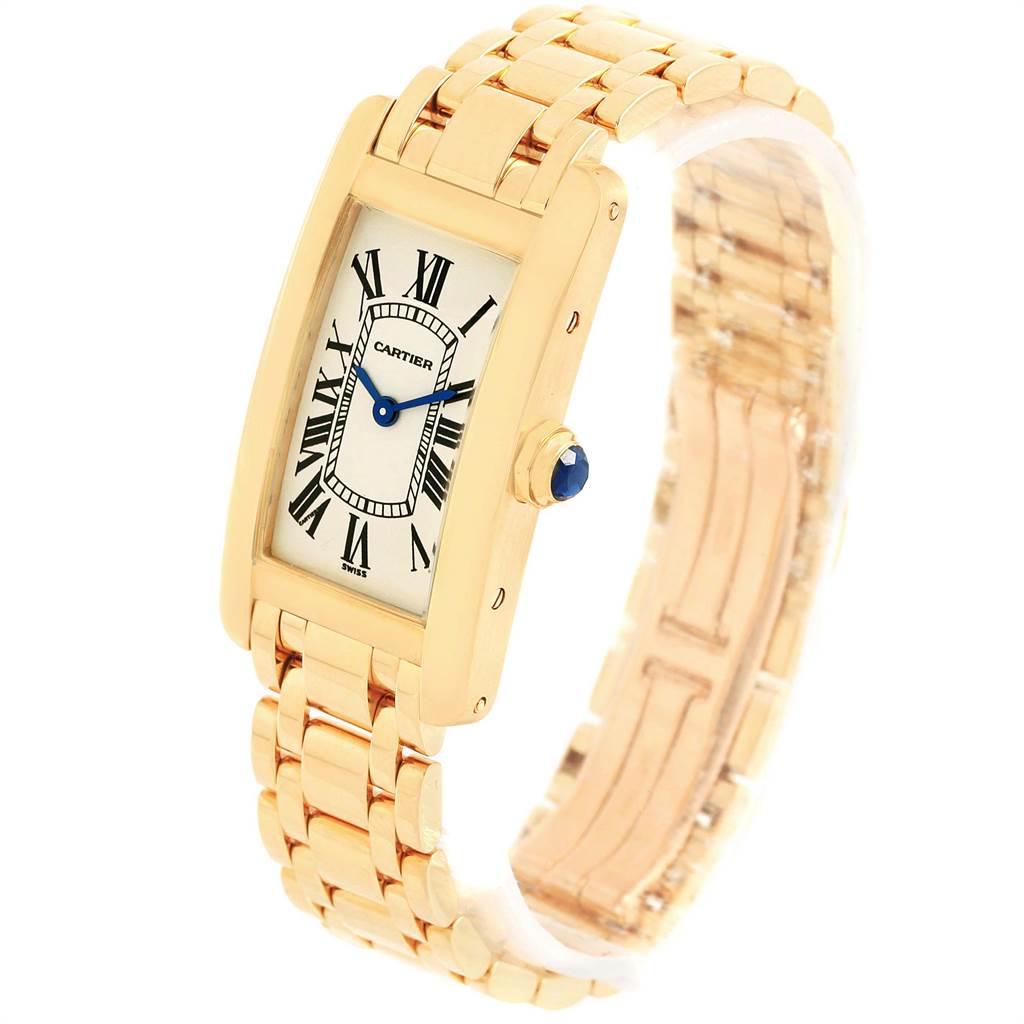 The image shows a Tank Americaine model by Cartier from a slight angle, highlighting the face, bezel, crown, and metal bracelet.