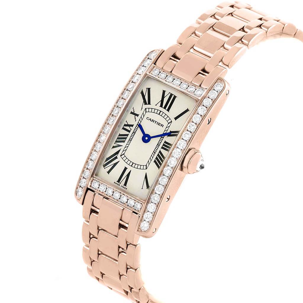 The image shows a Cartier Tank Americaine WB7079M5 Women's Rose Gold Silver Dial WB7079M5 Women's Rose Gold Silver Dial watch from an angled view, highlighting its rectangular face, diamond bezel, bracelet, and crown.