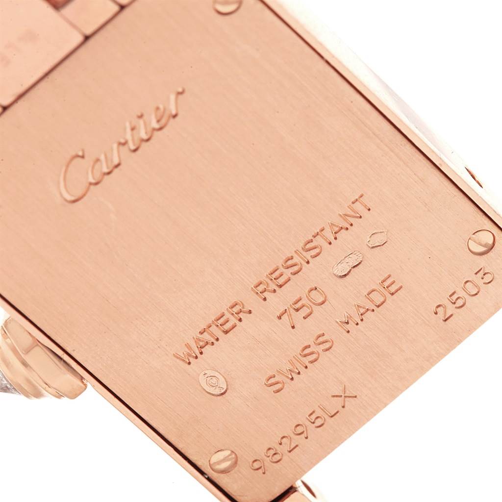 The image shows a close-up of the back case of the Cartier Tank Américaine watch, highlighting its engravings.