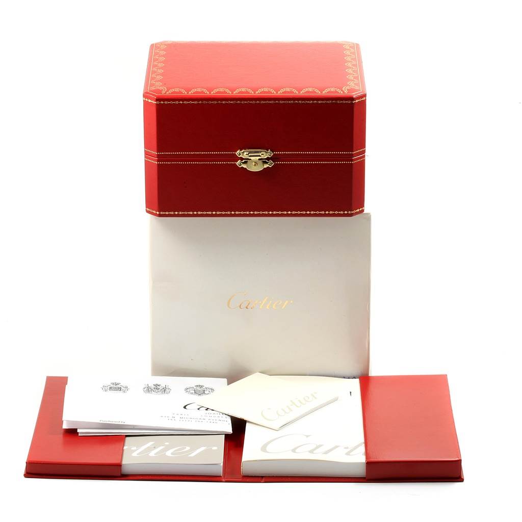 The image shows the packaging and documentation for the Cartier Tank Americaine WB7079M5 Women's Rose Gold Silver Dial WB7079M5 Women's Rose Gold Silver Dial, including a red box and booklets.