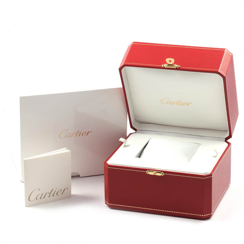 The image shows an open Cartier Tank Americaine W26015K2 Women's Yellow Gold Silver Dial W26015K2 Women's Yellow Gold Silver Dial watch box with accompanying booklets and accessories.