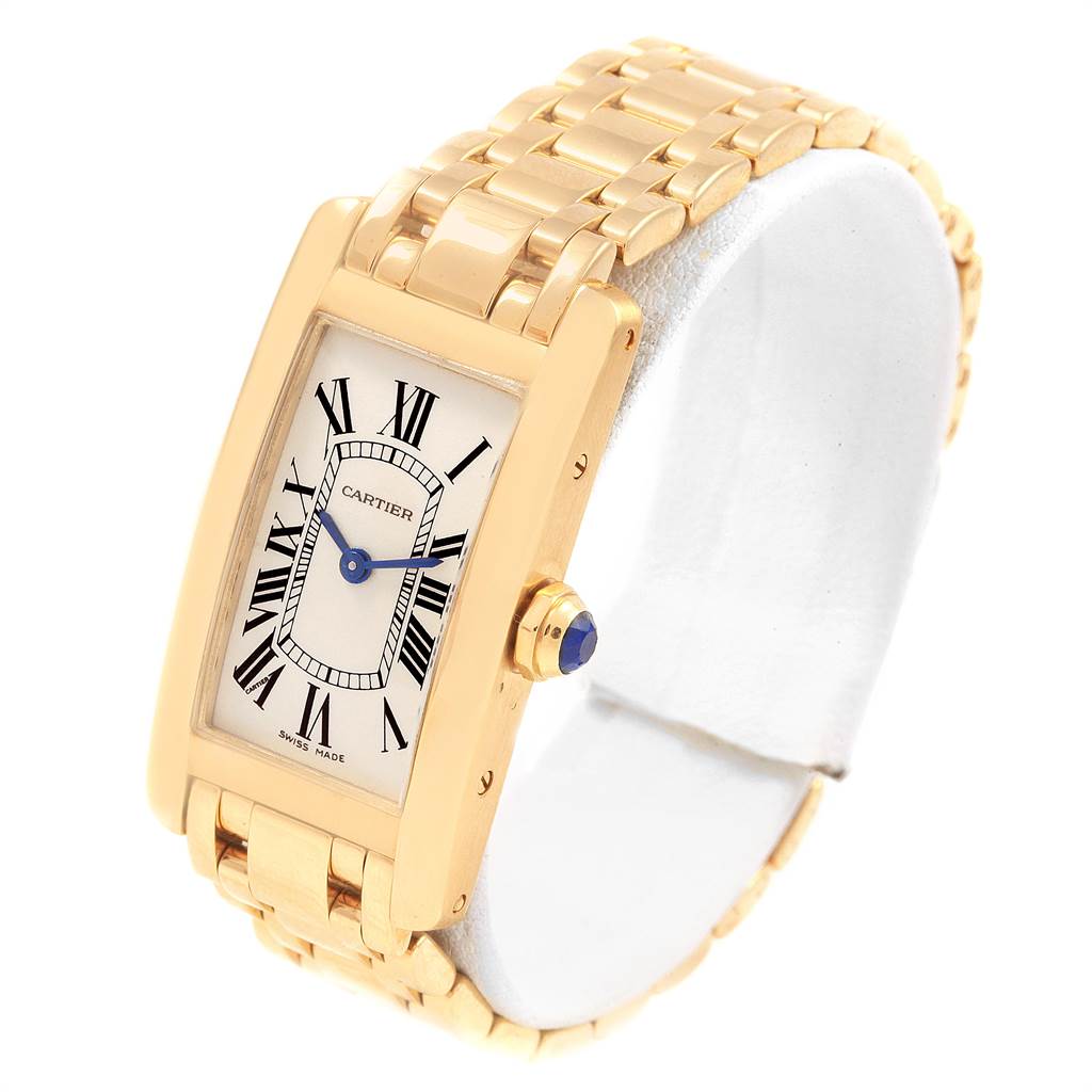 This image shows a Cartier Tank Americaine W26015K2 Women's Yellow Gold Silver Dial W26015K2 Women's Yellow Gold Silver Dial model watch from a front-side angle, highlighting the face, case, and bracelet.