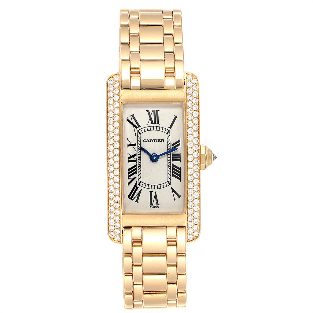 The image shows a frontal view of a Cartier Tank Americaine WB7012K2 Women's Yellow Gold Silver Dial WB7012K2 Women's Yellow Gold Silver Dial watch, including the face, bracelet, and bejeweled rectangular frame.