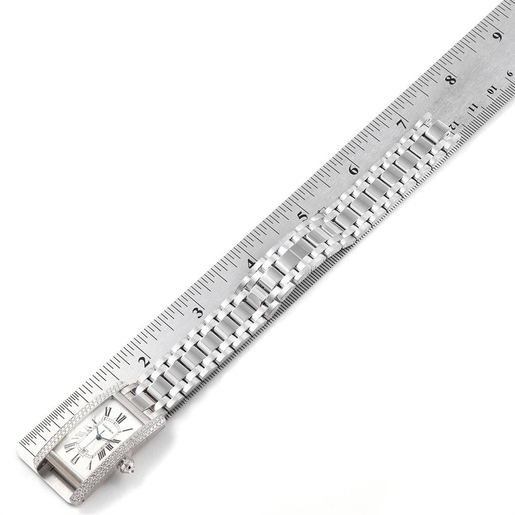 The image shows the face and strap of a Cartier Tank Américaine watch measured alongside a ruler.