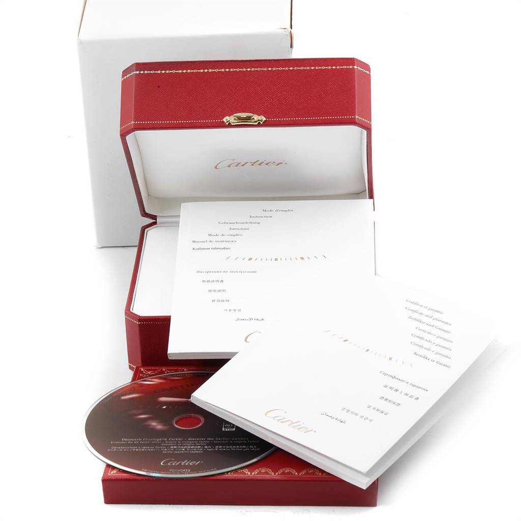 This image shows the red packaging box, instruction manuals, and CD for the Cartier Tank Americaine WB701851 Women's White Gold Silver Dial WB701851 Women's White Gold Silver Dial model watch.