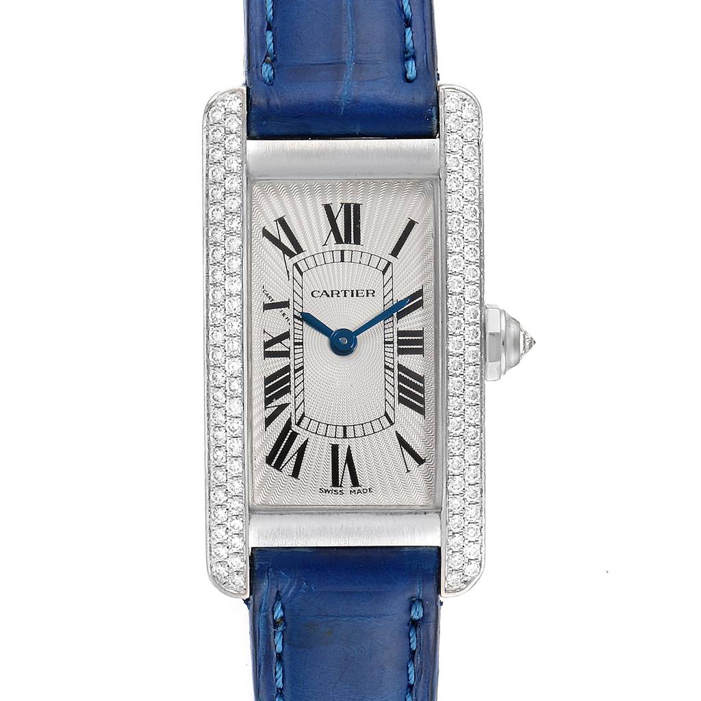 The image shows a frontal view of the Cartier Tank Americaine WB701851 Women's White Gold Silver Dial WB701851 Women's White Gold Silver Dial watch with a blue leather strap and diamond-encrusted bezel.