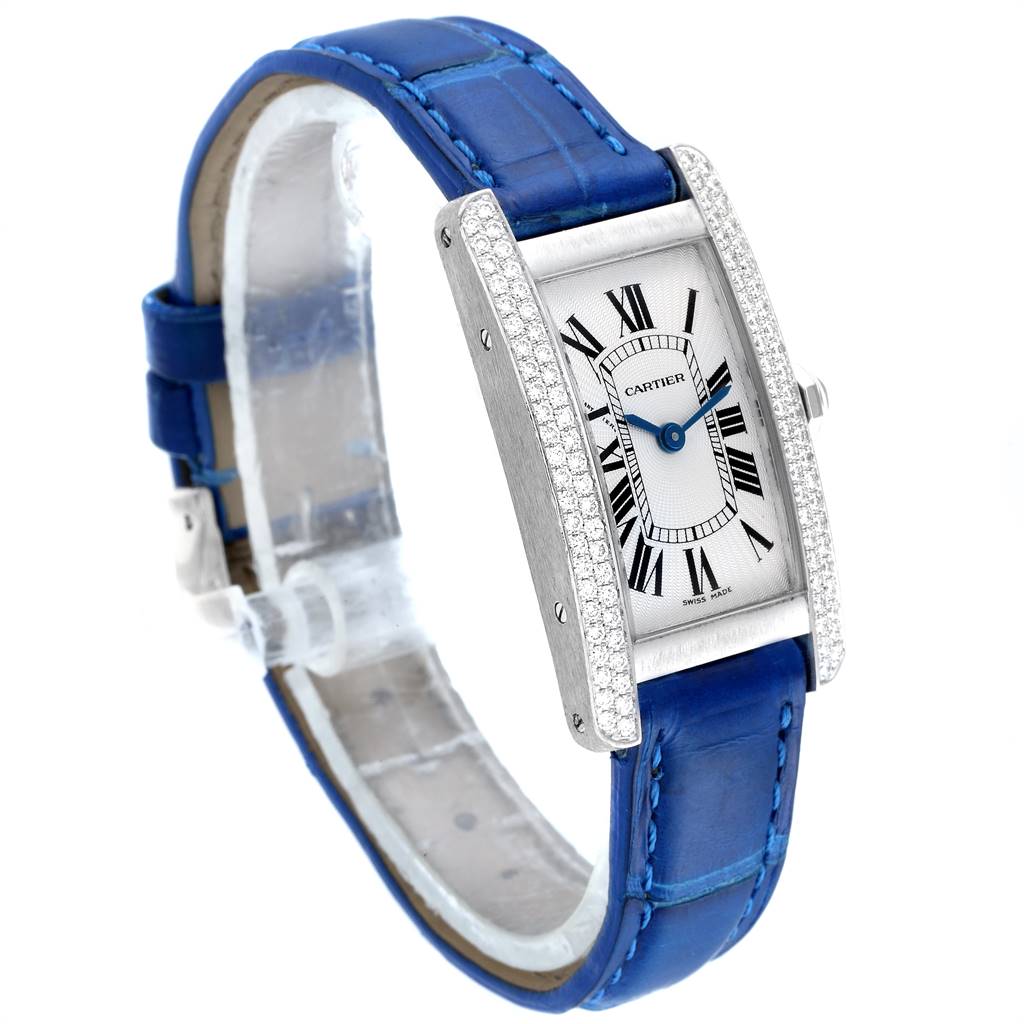 The Tank Americaine model by Cartier is shown at a three-quarter angle, highlighting the face, bezel, and blue strap.