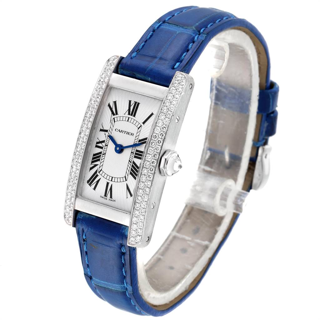 The image shows a Cartier Tank Americaine WB701851 Women's White Gold Silver Dial WB701851 Women's White Gold Silver Dial watch at a slight angle, highlighting its face, case, dial, and blue leather strap.