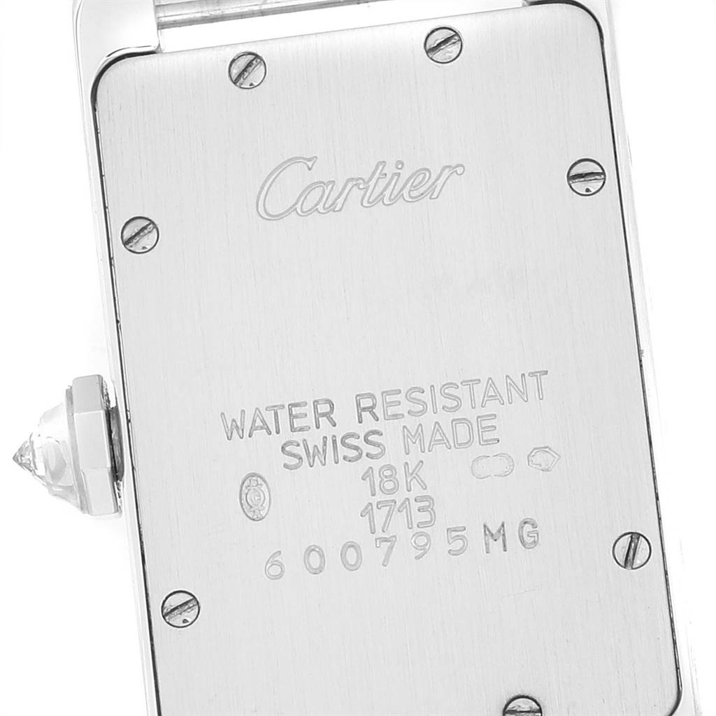 The image shows the back casing of a Cartier Tank Americaine WB7018L1 Women's White Gold Silver Dial WB7018L1 Women's White Gold Silver Dial watch, highlighting details and engravings.