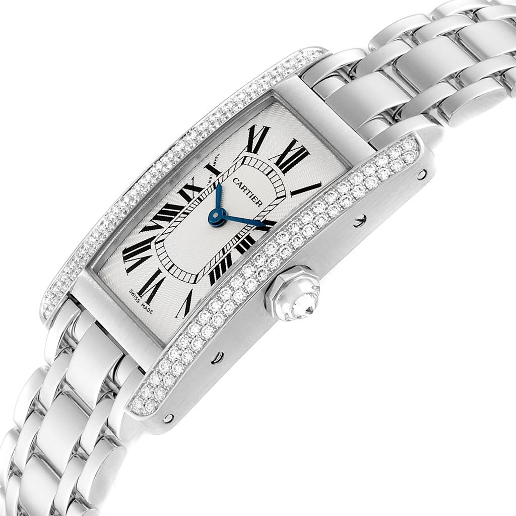 The image shows a Cartier Tank Americaine WB7018L1 Women's White Gold Silver Dial WB7018L1 Women's White Gold Silver Dial watch from a slight side angle, highlighting its diamond-studded case, bracelet, and crown.