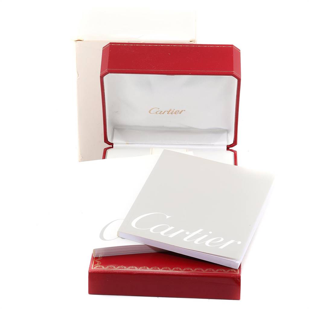 The image shows the packaging, including the red watch box and white booklet, for a Cartier Tank Americaine WB7018L1 Women's White Gold Silver Dial WB7018L1 Women's White Gold Silver Dial model watch.