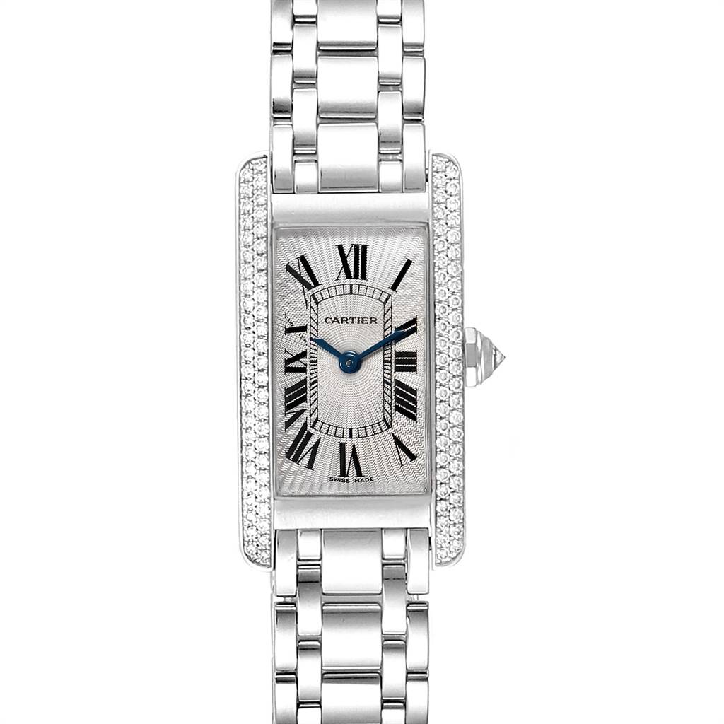 The image shows a front view of a Cartier Tank Americaine WB7018L1 Women's White Gold Silver Dial WB7018L1 Women's White Gold Silver Dial watch with a rectangular face, Roman numerals, and a metal bracelet.