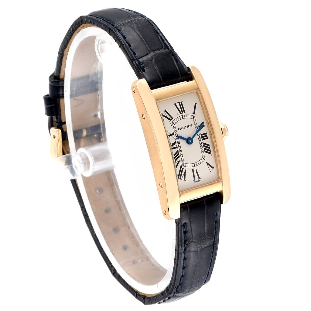 The Cartier Tank Americaine W2601556 Women's Yellow Gold Silver Dial W2601556 Women's Yellow Gold Silver Dial watch is displayed at a three-quarter angle showing the face, strap, and gold casing.