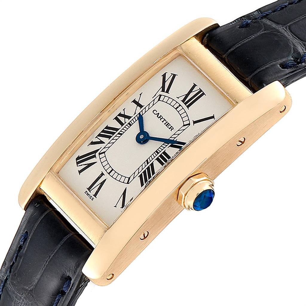 The image shows a close-up of the Cartier Tank Américaine watch focusing on its face, bezel, strap, and crown.