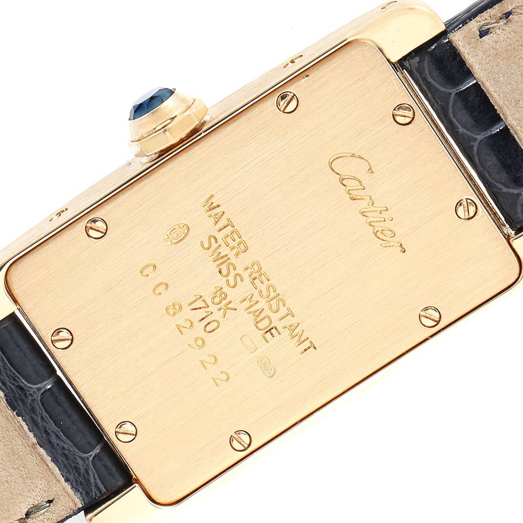 The image shows the back, strap, and crown of the Cartier Tank Americaine W2601556 Women's Yellow Gold Silver Dial W2601556 Women's Yellow Gold Silver Dial watch at an angle.