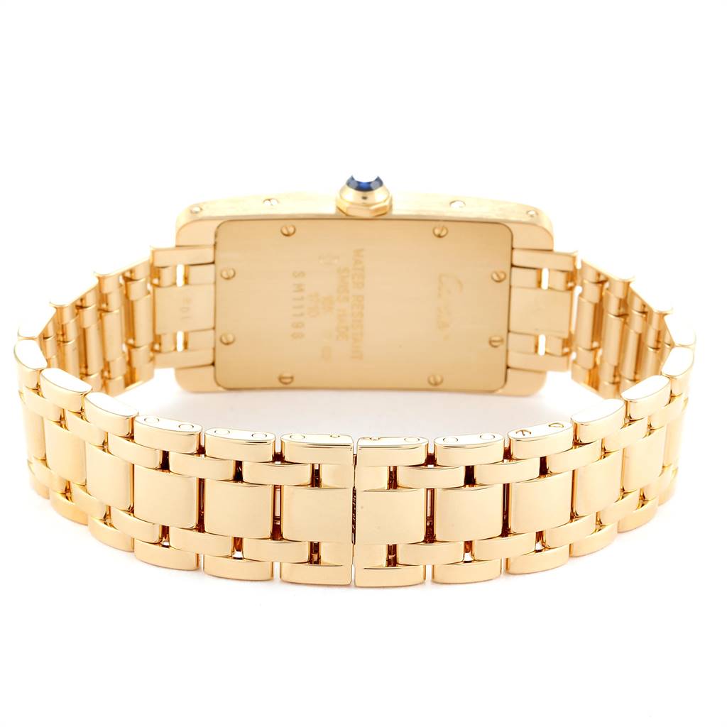 This image shows the back view of a Cartier Tank Américaine watch, highlighting its gold case and bracelet.