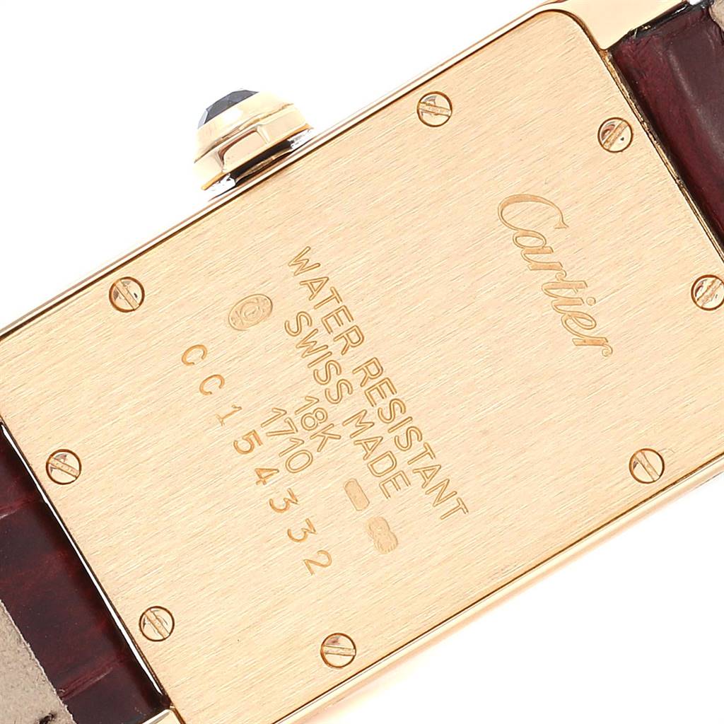 This image shows the back case of a Cartier Tank Américaine watch, highlighting the engraving and screws.