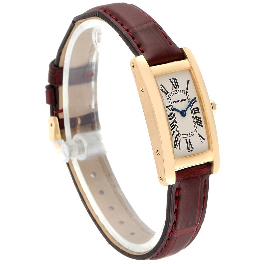 The image shows a Cartier Tank Americaine W2601556 Women's Yellow Gold Silver Dial W2601556 Women's Yellow Gold Silver Dial watch at a three-quarter angle, highlighting its face, leather strap, and side profile.