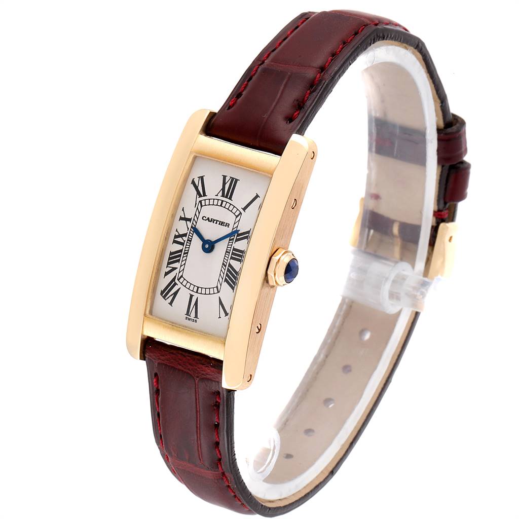 The image shows a Cartier Tank Américaine watch angled slightly from the side, highlighting its rectangular face, leather strap, and crown.