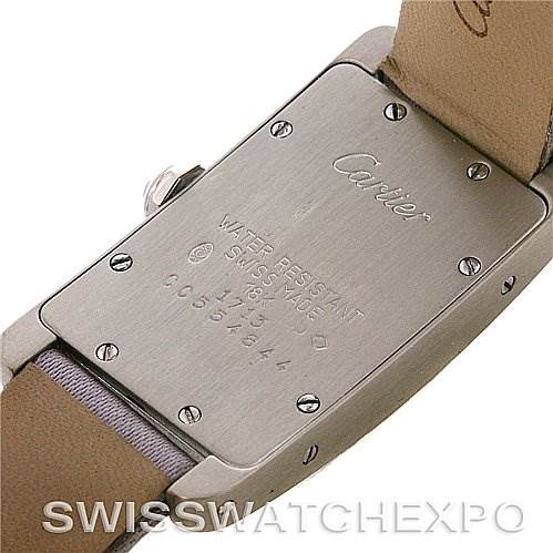 The image shows the back case of the Cartier Tank Americaine Women
s White Gold Silver Dial Women
s White Gold Silver Dial watch, highlighting the screws and engravings.