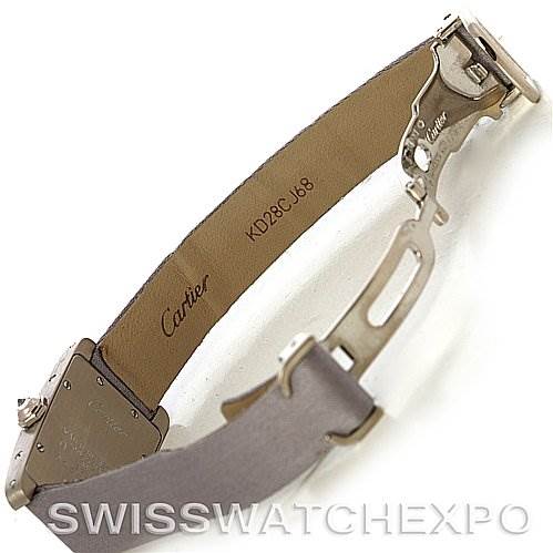 The image shows the underside and clasp mechanism of a Cartier Tank Américaine watch, with emphasis on the strap and buckle.